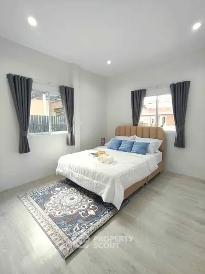 Bright and cozy bedroom with elegant decor and natural light, perfect for relaxation and comfort.