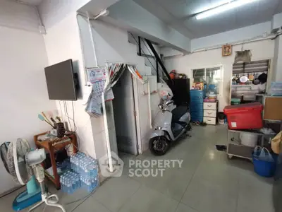 Cozy interior space with scooter, TV, and storage, ideal for urban living.