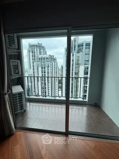 Modern apartment balcony with stunning city view and sleek glass doors