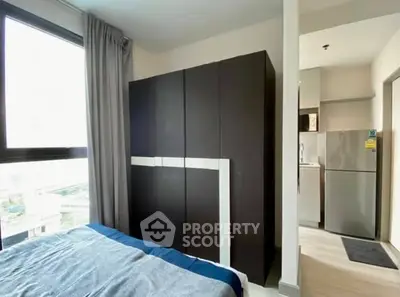 Modern bedroom with large wardrobe and view of adjacent kitchen area.