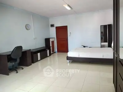 Spacious bedroom with modern furniture and study area