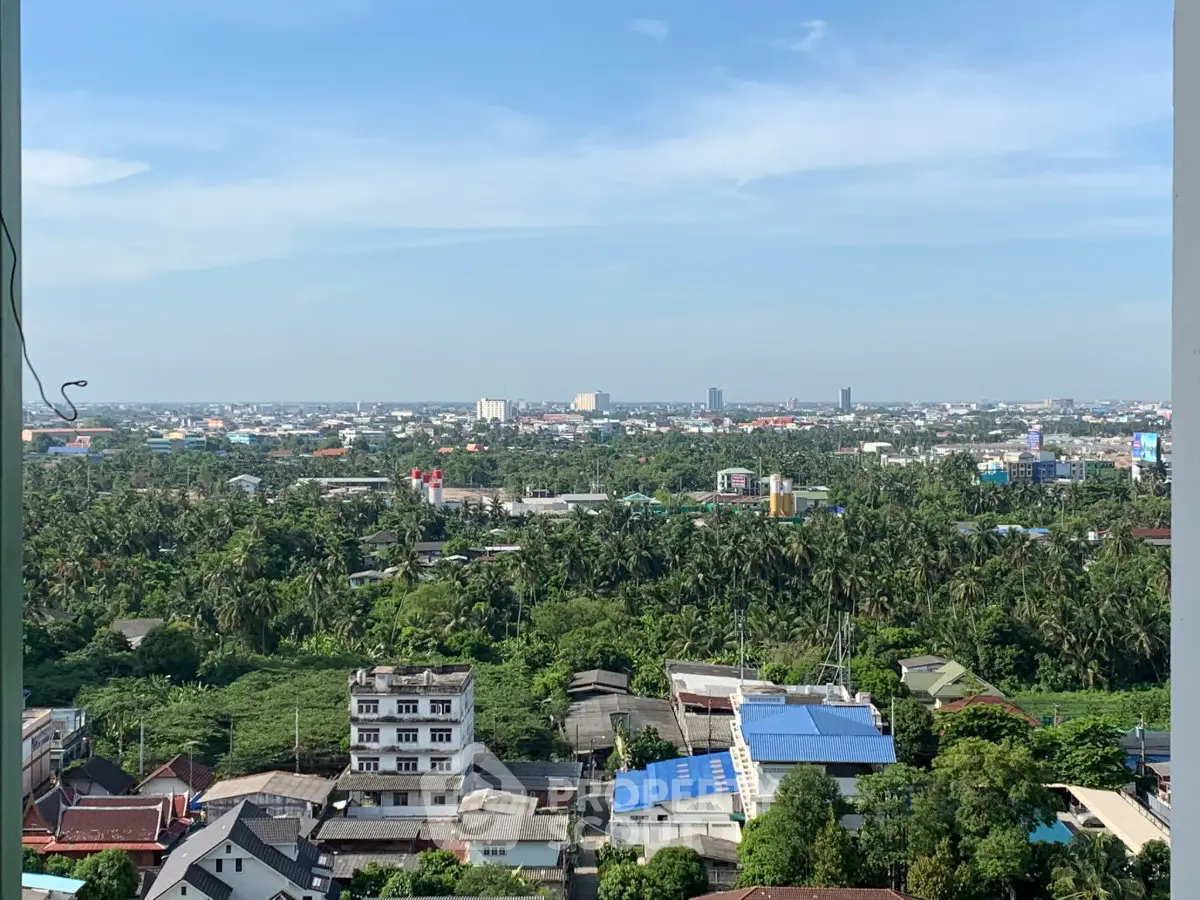 Stunning panoramic cityscape view from high-rise apartment balcony.