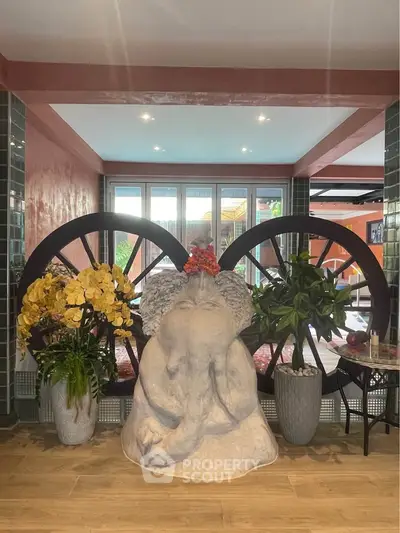 Stylish interior with unique sculpture and vibrant decor in modern living space.