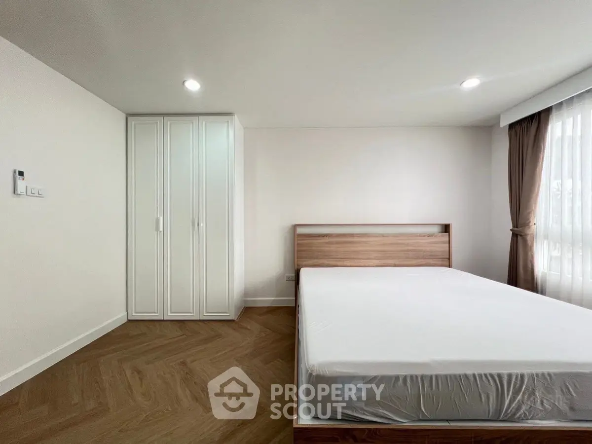 Spacious bedroom with modern design and ample natural light