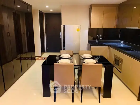 Modern kitchen with sleek cabinetry and dining area in luxury apartment