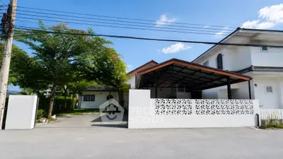 Charming suburban home with spacious driveway and lush greenery, perfect for family living.