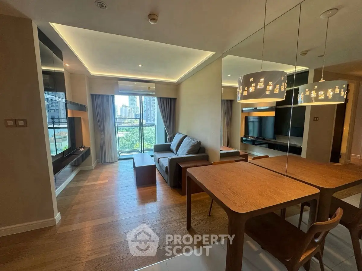 Modern living room with stylish furniture and large windows offering city views