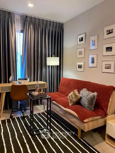 Stylish living room with modern decor, cozy sofa, and chic workspace corner.