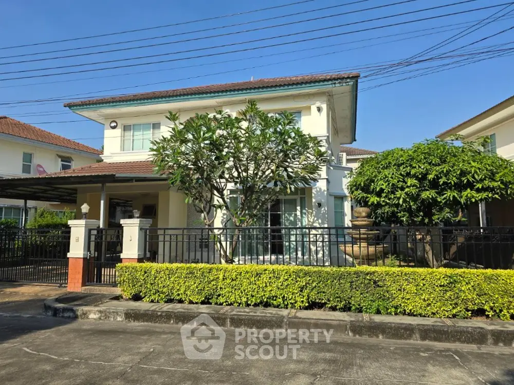 Charming two-story house with lush garden and modern exterior design in a serene neighborhood.