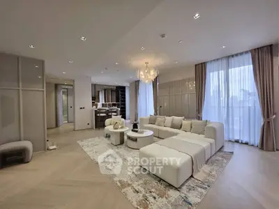 Luxurious modern living room with elegant chandelier and spacious seating area