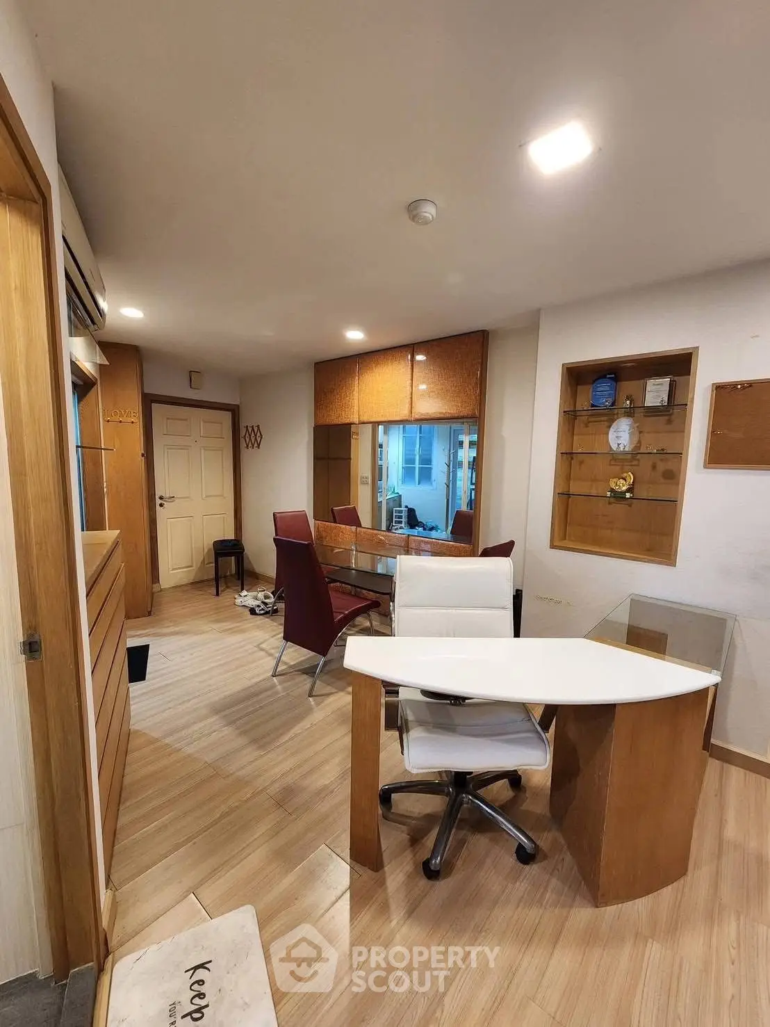 Modern study room with sleek furniture and wooden flooring, perfect for productivity and comfort.