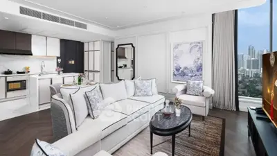 Luxurious modern living room with open kitchen and city view, featuring elegant decor and spacious layout.