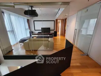 Spacious modern living room with hardwood floors and large windows