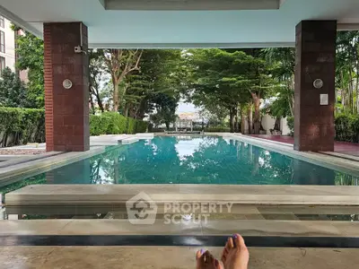 Luxurious poolside view with lush greenery and serene ambiance