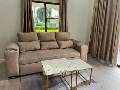 Cozy living room with plush sofa and elegant marble coffee table, perfect for relaxation.