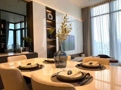 Luxurious modern dining area with elegant table setting and floor-to-ceiling windows offering stunning city views.