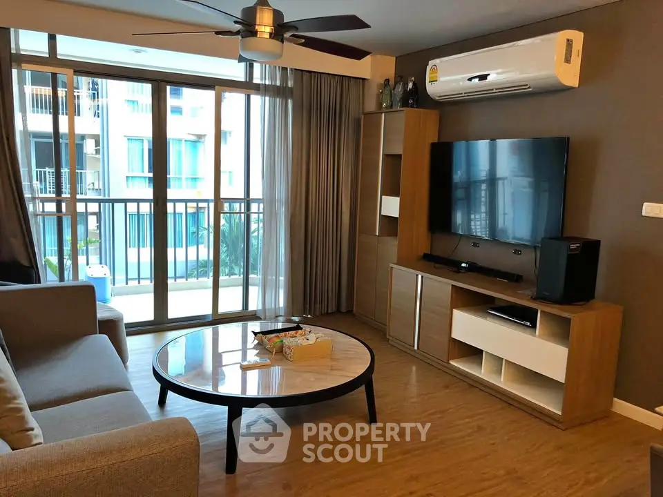 Modern living room with large windows and stylish furniture in a contemporary apartment.