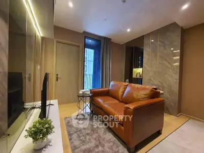Modern living room with leather sofa and stylish decor in a luxury apartment.