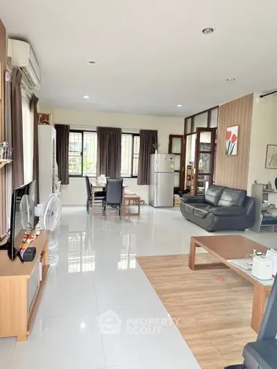 Spacious open-plan living room with modern furnishings and natural light.