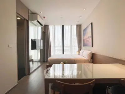 Modern bedroom with large windows and stylish decor in a high-rise apartment.