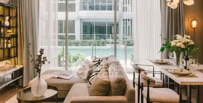 Luxurious living room with pool view, elegant decor, and modern furnishings.