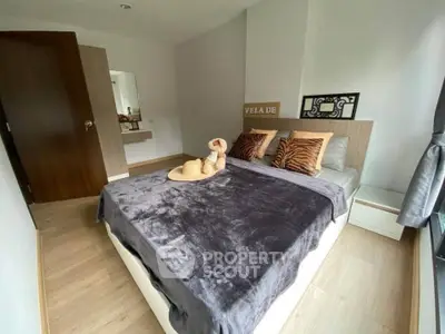Cozy bedroom with modern decor and large window for natural light