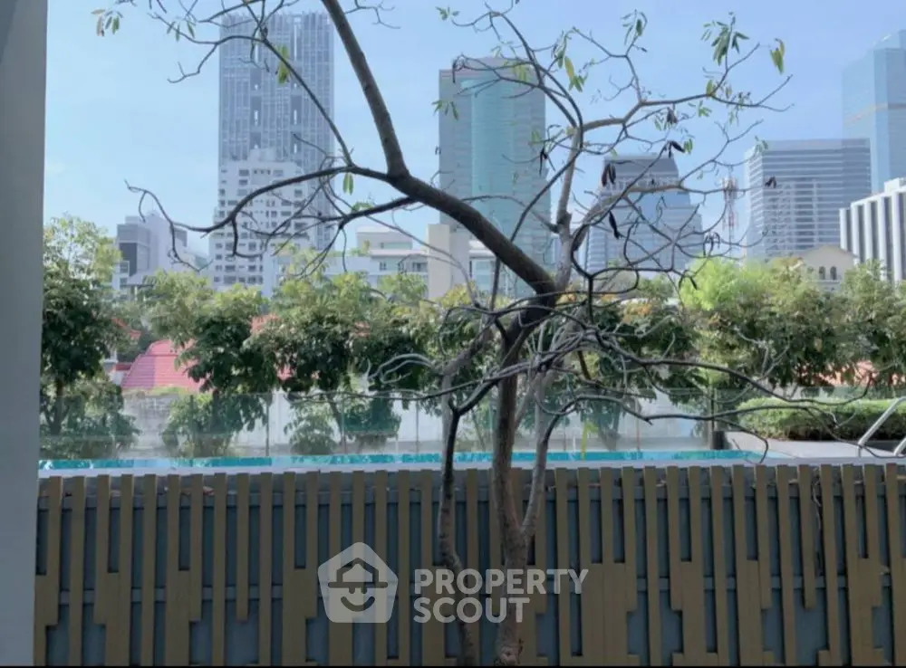 Urban view with pool and city skyline, perfect for modern living.