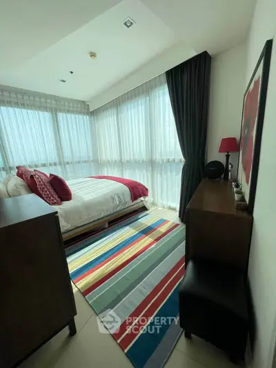 Chic bedroom with panoramic windows and vibrant decor in modern apartment