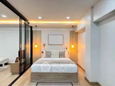 Modern bedroom with stylish lighting and cozy decor in a contemporary apartment.