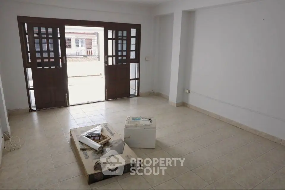 Spacious empty room with large windows and tiled floor, perfect for customization.