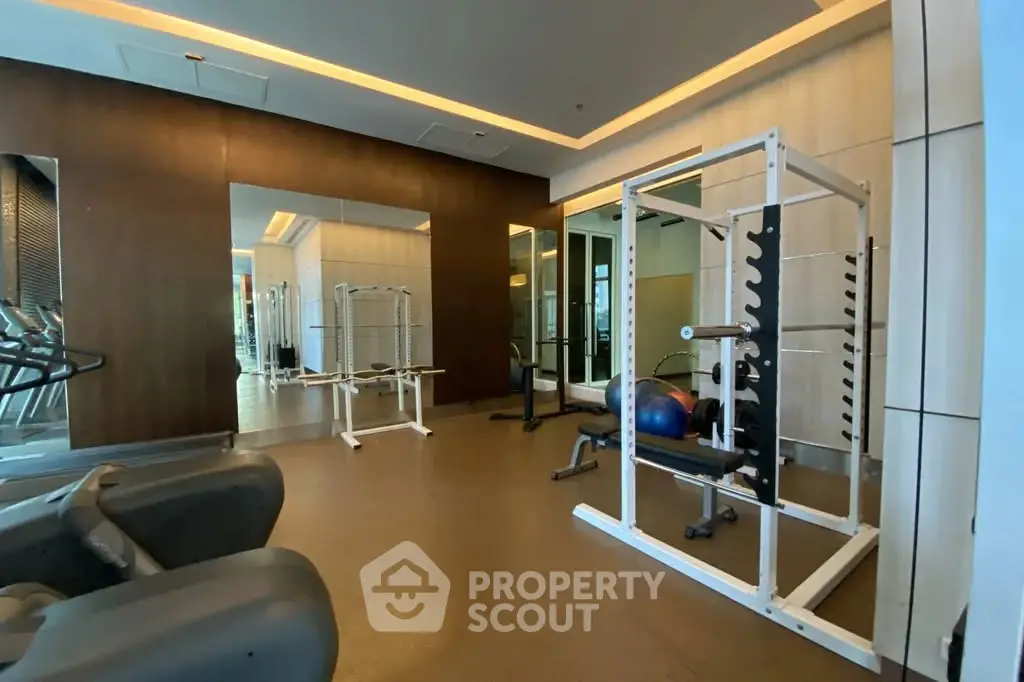 Modern gym with state-of-the-art equipment in luxury residential building.