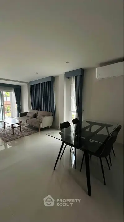 Spacious living room with modern furniture and large windows for natural light.