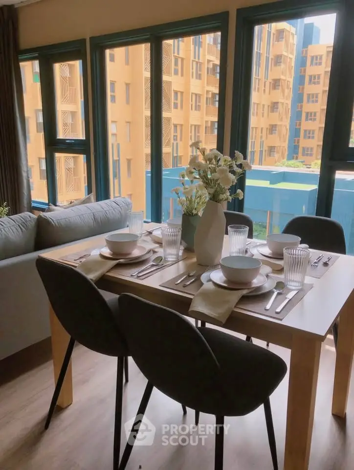 Stylish dining area with modern table setting and city view, perfect for urban living.