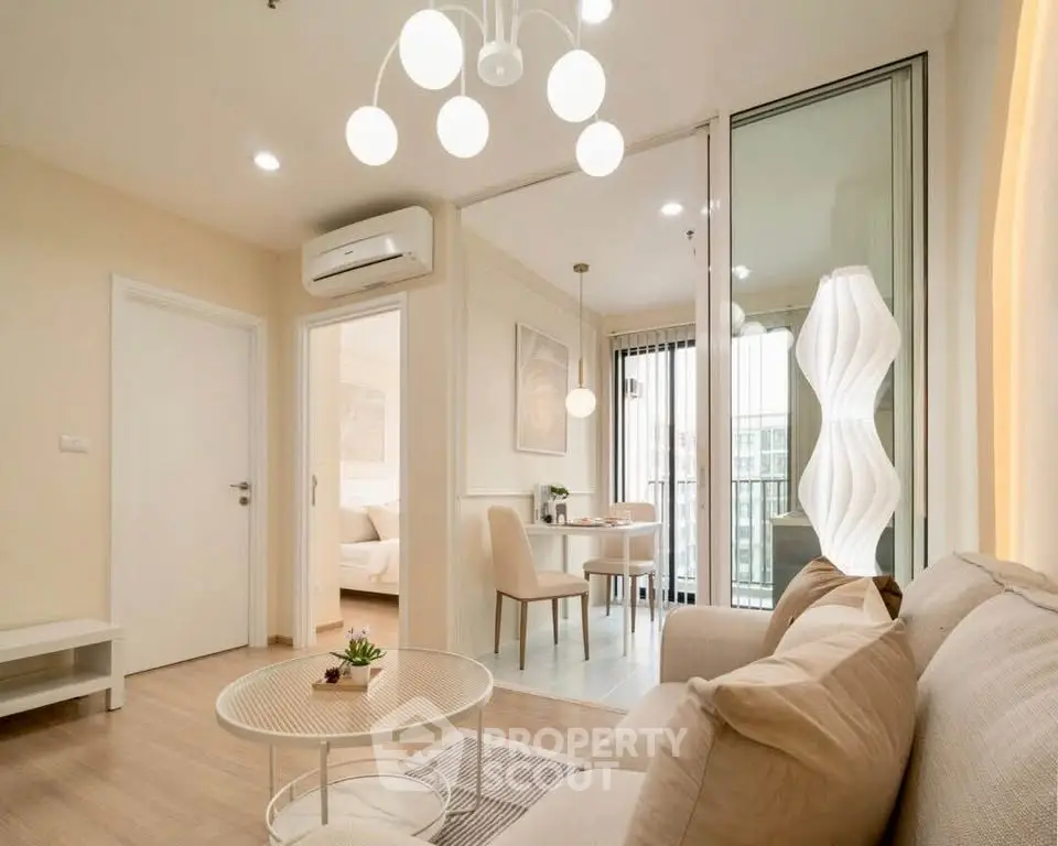 Modern living room with elegant decor and open layout leading to dining area and balcony.