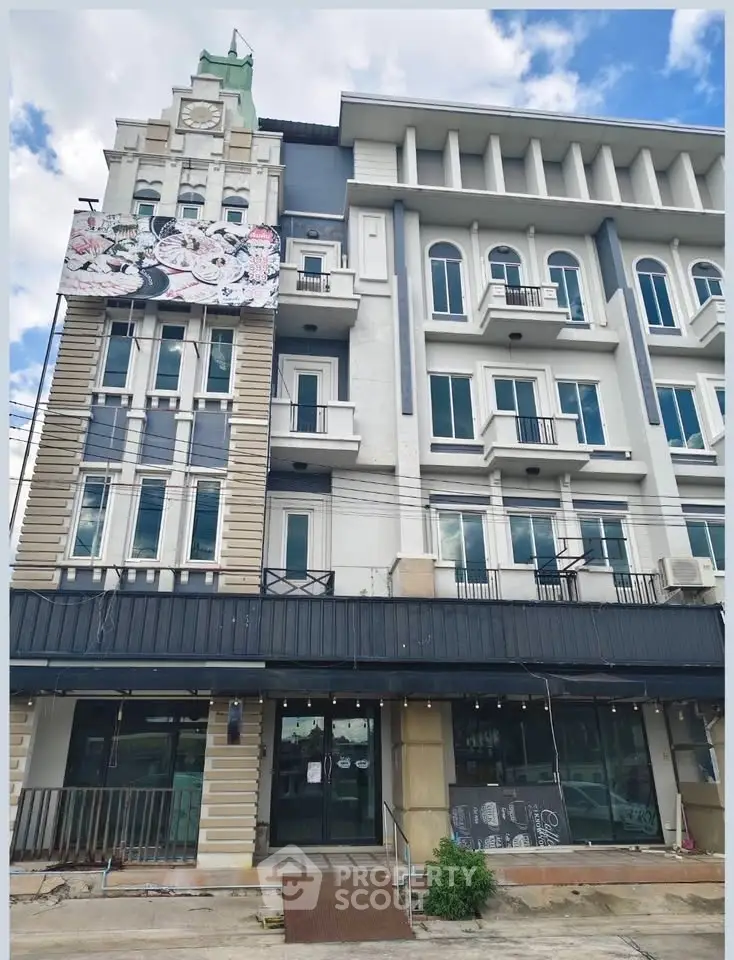 Stunning multi-story building with elegant facade and balconies, perfect for commercial or residential use.