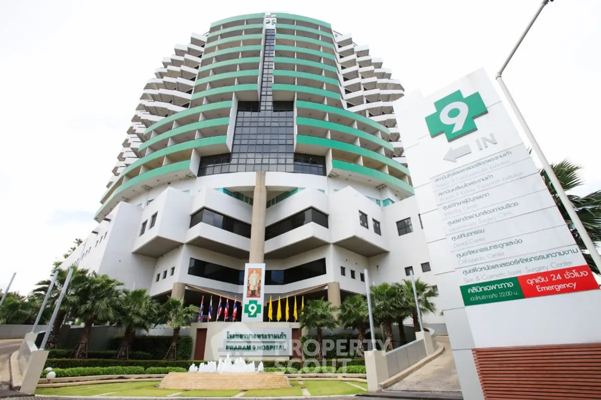 Modern hospital building with unique architecture and green accents, featuring a welcoming entrance and clear signage.