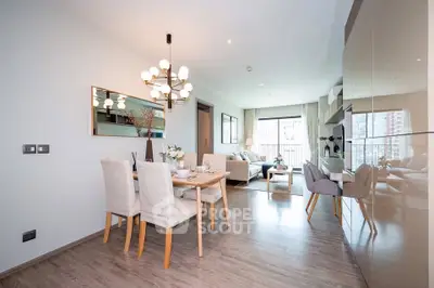 Modern open-plan living and dining area with elegant decor and natural light.