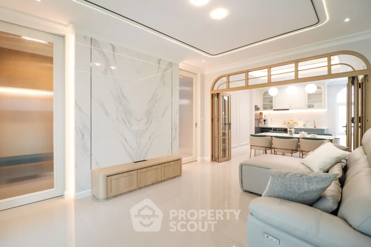 Luxurious open-plan living room with modern decor and elegant dining area