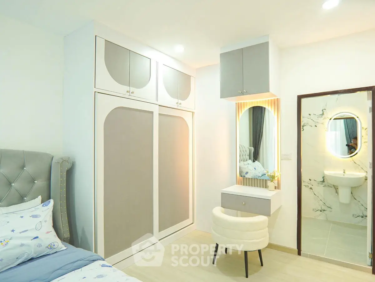 Elegant bedroom with modern wardrobe and stylish vanity area
