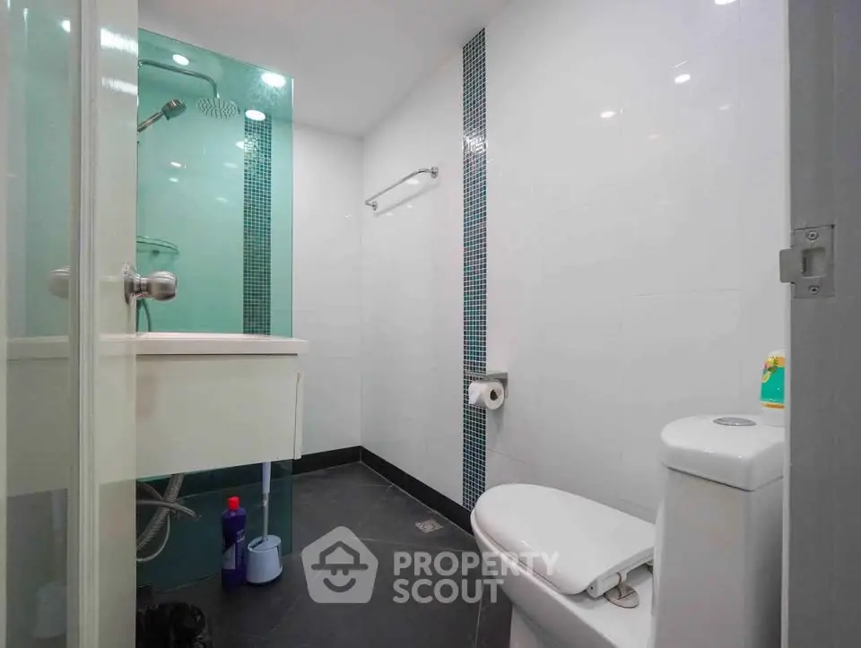 Modern bathroom with sleek design and contemporary fixtures in a real estate property.
