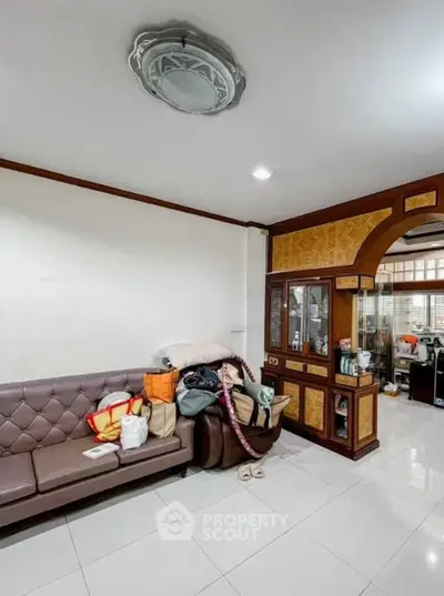 Spacious living room with elegant decor and ample seating, perfect for relaxation and gatherings.