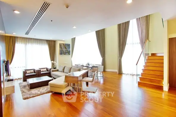 Spacious modern living room with wooden flooring and elegant decor