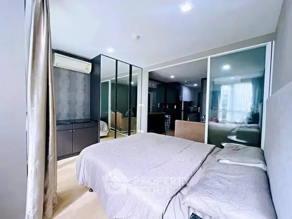 Modern bedroom with mirrored wardrobe and soft lighting
