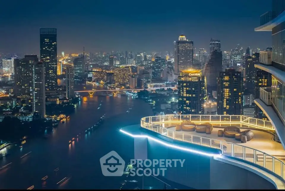 Stunning rooftop view of city skyline and river from luxury high-rise building at night.
