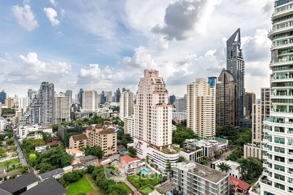 Stunning cityscape view showcasing modern high-rise buildings and lush greenery in an urban setting.