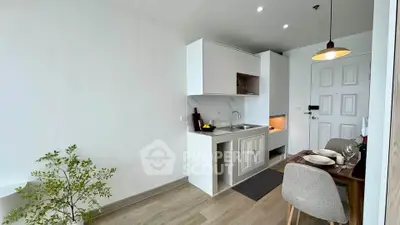 Modern compact kitchen with dining area in a stylish apartment