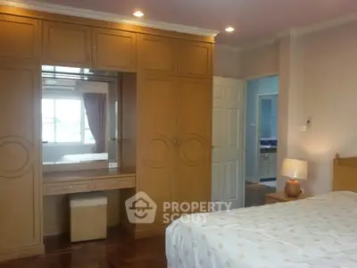 Spacious bedroom with built-in wardrobe and cozy lighting