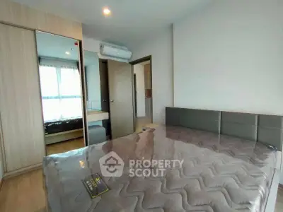 Modern bedroom with stylish decor and natural light in a contemporary apartment.