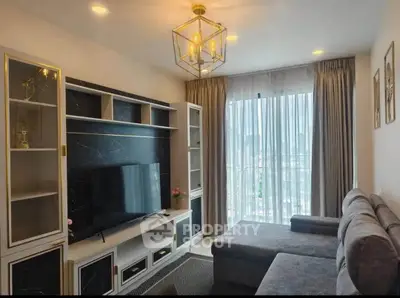 Modern living room with stylish decor and large window offering city views.