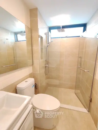 Modern bathroom with glass shower and large mirror